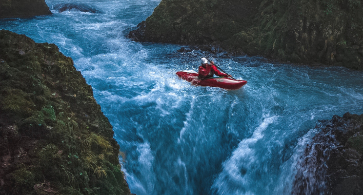 A kayaking person on a turbulent river