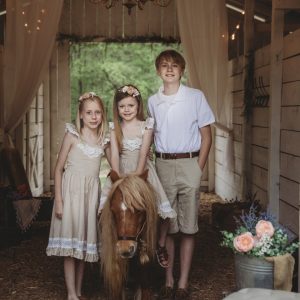 children portrait inside a barn with horse